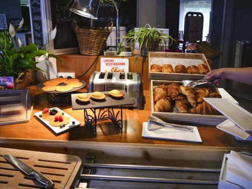 a counter with a bunch of pastries and other pastries at ibis Nemours in Nemours