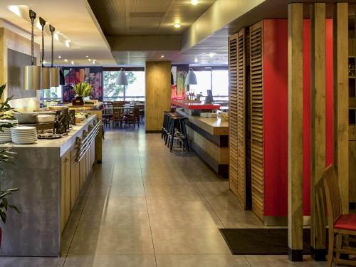 a restaurant with a kitchen and a dining room at ibis Paris Porte d'Italie in Paris