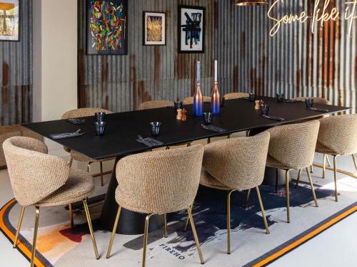 a black table with chairs and wine bottles on it at ibis Paris Porte D'Orleans in Montrouge