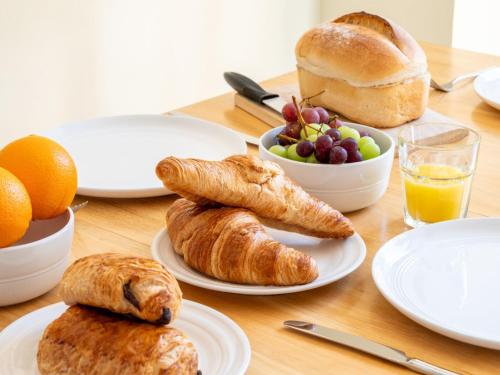 a table topped with plates of pastries and fruit at 2 Bed in Chulmleigh 72791 in Coldridge