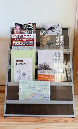 a stack of books sitting on a shelf at Hot Spring Guest House Mikunien - Vacation STAY 18669v in Sakai