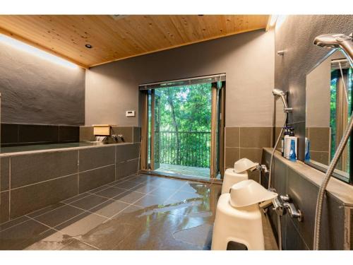 a bathroom with a shower and a toilet and a window at Keyakizaka - Vacation STAY 12550v in Ogi