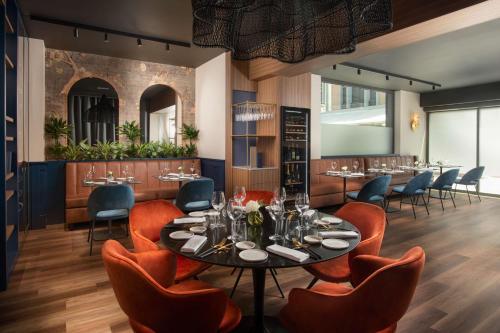 a dining room with a table and chairs at NH Collection Roma Centro in Rome