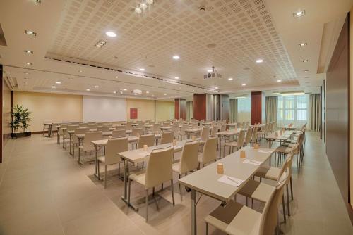an empty banquet hall with tables and chairs at NH Collection Roma Centro in Rome