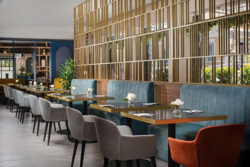 a row of tables and chairs in a restaurant at NH Collection Roma Centro in Rome