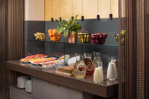 a buffet with food and drinks on a table at NH Collection Roma Centro in Rome