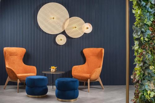 two chairs and a table in a room at NH Collection Roma Centro in Rome