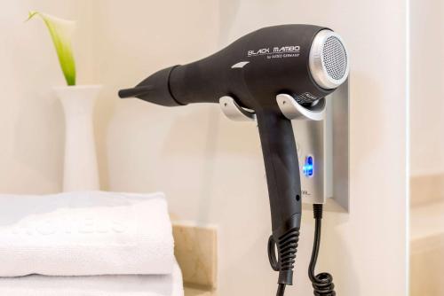 a blow dryer is attached to a wall at NH Collection Roma Centro in Rome