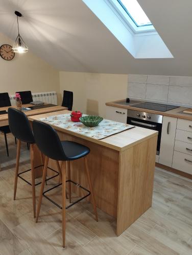 a kitchen with a island with a bowl on it at Belgrade City Home Beograd in Belgrade