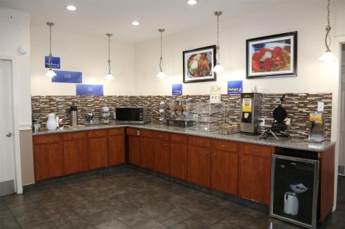 a large kitchen with a counter top in a room at Americas Best Value Inn Monroe in Monroe