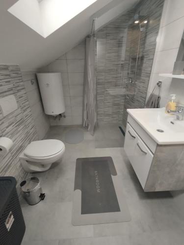 a bathroom with a toilet and a sink at Belgrade City Home Beograd in Belgrade