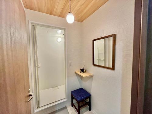a bathroom with a mirror and a blue stool at Onomichi Stay Gen - Vacation STAY 24149v in Onomichi