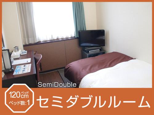 a hotel room with a bed and a television at Hotel Abest Osu Kannon Ekimae Hane no Yu in Nagoya