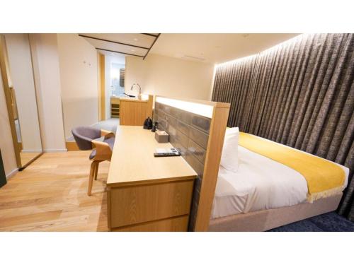 a hotel room with a bed and a desk at THE GALA HOTEL UMEDA - Vacation STAY 24233v in Osaka