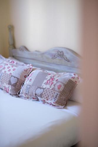 a white bed with two pillows on it at Casa Maza Apartamentos in Biescas