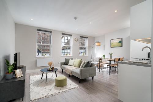 a living room with a couch and a table at Stylish apartment in the heart of Kingston Town Centre in Kingston upon Thames