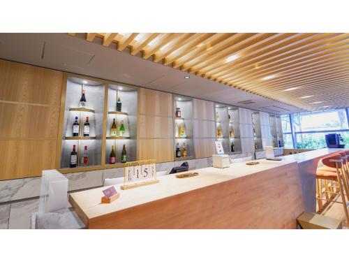 a wine store with bottles of wine on the wall at THE GALA HOTEL UMEDA - Vacation STAY 24210v in Osaka