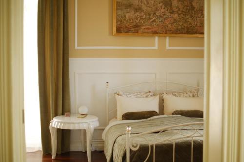 a bedroom with a bed and a side table at Villa Várzea - Garden Suite in Várzea