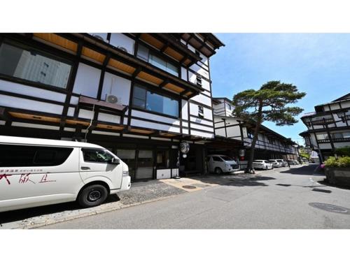 a white van parked in front of a building at Osakaya Ryokan - Vacation STAY 30202v in Kusatsu
