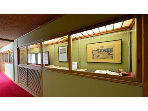 a room with a row of mirrors on a wall at Osakaya Ryokan - Vacation STAY 30203v in Kusatsu