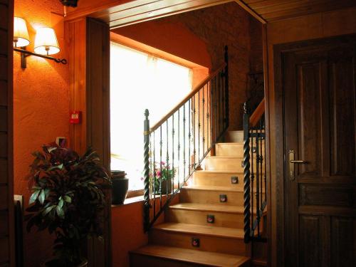 a staircase in a house with a large window at C.T.R. Camino de la Fuentona in Cabrejas del Pinar