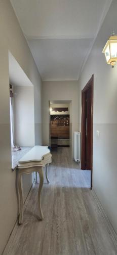 an empty room with a table and a hallway at B&B Cascina Barolo in Turin
