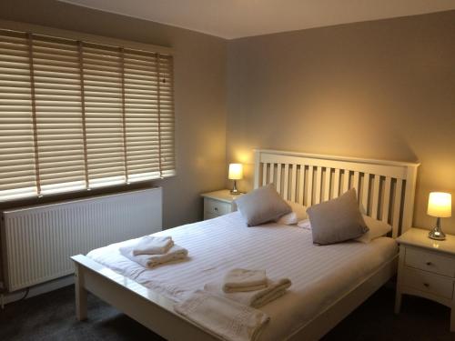 a bedroom with a bed with two towels on it at Valley Mount House & Apartment in Harrogate