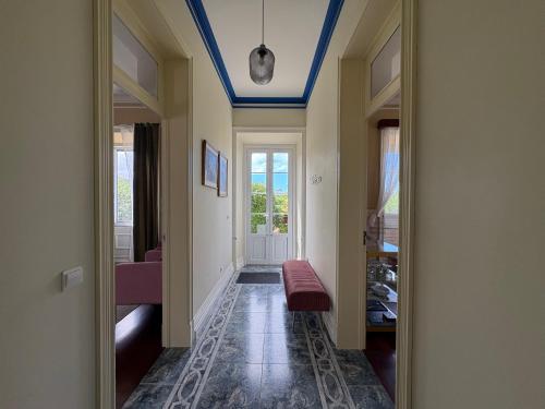 a hallway with a blue ceiling and a mirror at Villa Várzea - Garden Suite in Várzea
