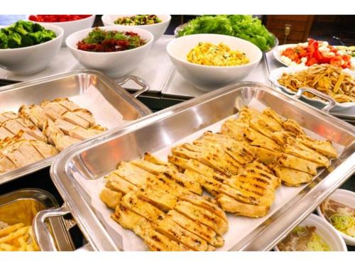 a buffet with several trays of food on a table at Takamine Kogen Hotel - Vacation STAY 36239v in Shin-kazawa