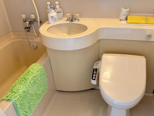 a small bathroom with a sink and a toilet at Takamine Kogen Hotel - Vacation STAY 36239v in Shin-kazawa