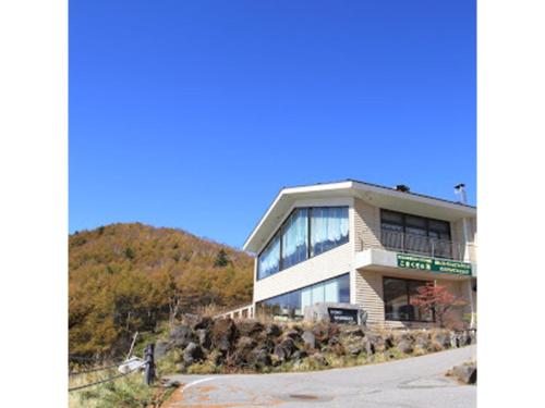 a building on the side of a hill at Takamine Kogen Hotel - Vacation STAY 36239v in Shin-kazawa