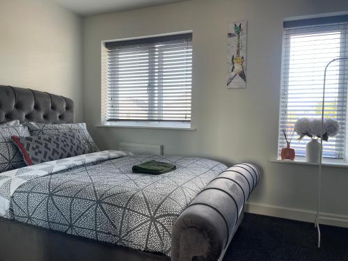 a bedroom with a large bed with a large fan at Davenport drive in Giltbrook