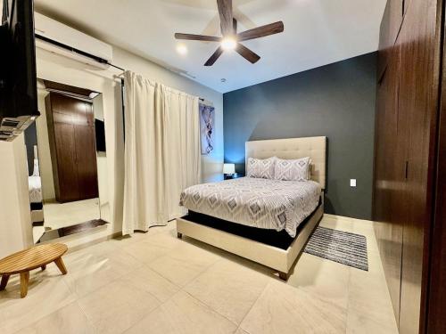 a bedroom with a bed and a ceiling fan at Your escape in Cabo Comfortable and elegant apartment in Cabo San Lucas