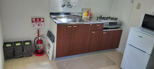 a small kitchen with a sink and a microwave at Forest - Vacation STAY 34213v in Tateyama