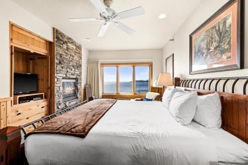 a bedroom with a large bed and a television at Majestic Lake Views 1BR King Suite and Heated Pools in Two Harbors