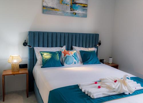 a bedroom with a large bed with towels on it at Boutique Hotel Luz da Lua in Ponta do Sol
