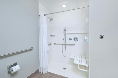 a bathroom with a shower with a shower curtain at Courtyard by Marriott Oahu North Shore in Laie