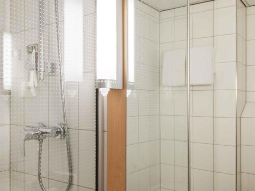 a bathroom with a shower with a glass door at Ibis Schiphol Amsterdam Airport in Badhoevedorp