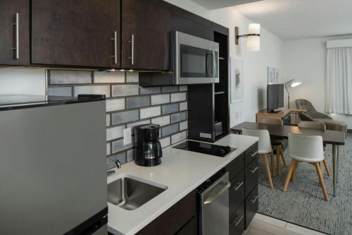 a kitchen with a sink and a counter top at TownePlace Suites by Marriott Foley at OWA in Foley