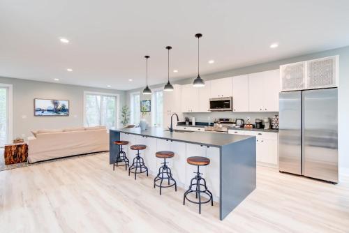 a kitchen with a large island with bar stools at Modern Family Cabin 1 min to Bryce Fire Pit KING Bed in Basye