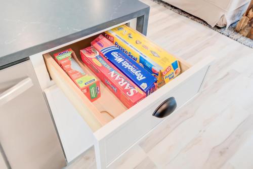 a drawer of a desk with some snacks in it at Modern Family Cabin 1 min to Bryce Fire Pit KING Bed in Basye