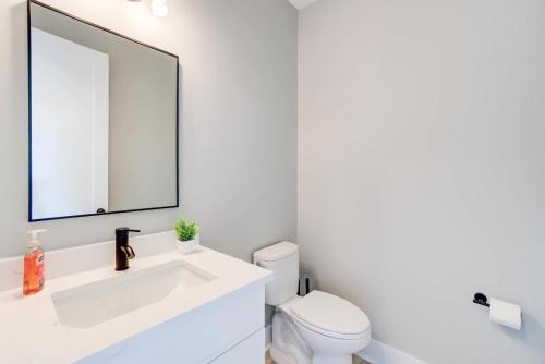 a white bathroom with a sink and a mirror at Modern Family Cabin 1 min to Bryce Fire Pit KING Bed in Basye