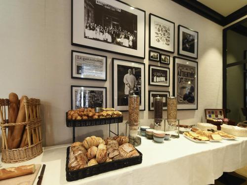 a table with bread and pastries on it at ibis Styles Dijon Central in Dijon