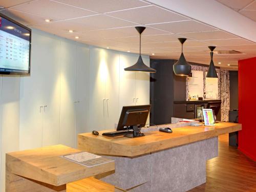 an office with a desk with a computer on it at ibis Poitiers Sud in Poitiers