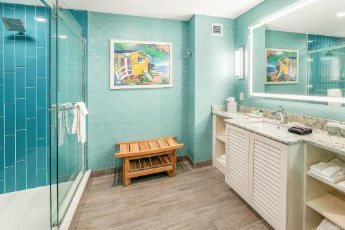a bathroom with a shower and a sink and a bench at Margaritaville Resort Gatlinburg in Gatlinburg