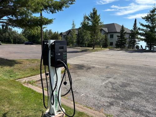 a pay phone sitting on the side of a street at Majestic Lake Views Studio 2-Queen Beds and Heated Pools in Two Harbors