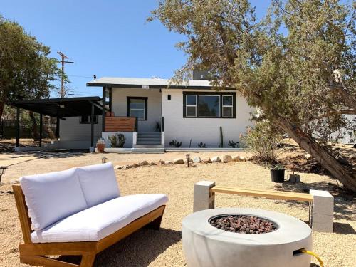a couch and a fire pit in front of a house at Joshua Tree - Under the Stars-Pool, Spa & Fire pit in Yucca Valley