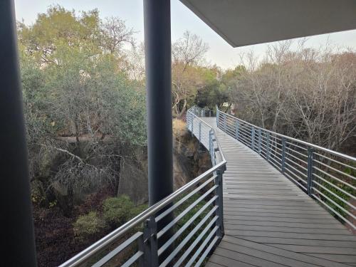 a boardwalk over a river with a bridge at 13 Sunningdale - Jackals Creek Golf Estate in Roodepoort