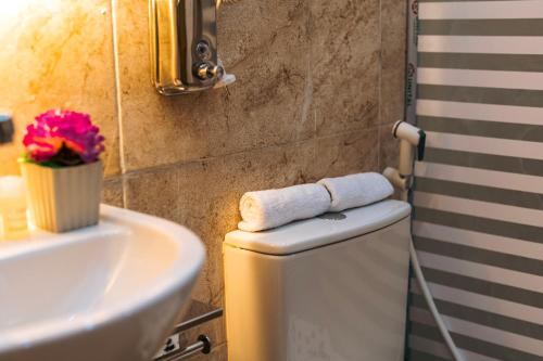 a bathroom with a sink and a toilet with towels at Orienta view pyramids in Cairo