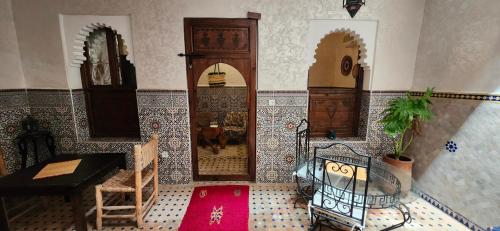 a room with wooden doors and tiled walls and a floor at Riad Dar Si Driss in Marrakech